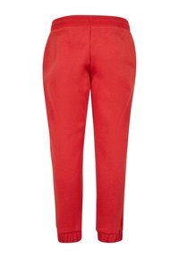 Pantalones de chándal rojos hechos de una suave mezcla de algodón, con una cintura elástica y puños ajustados para un ajuste cómodo. Sin bolsillos ni estampados.