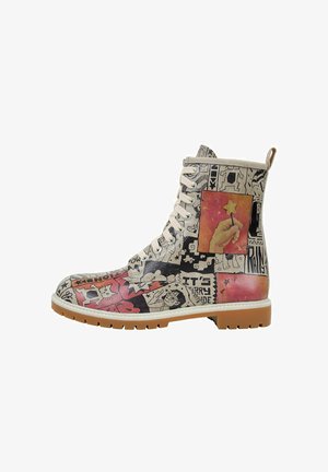 Graphic combat boot featuring a colorful collage design, predominantly beige with red and black accents, white laces, and a rubber sole.