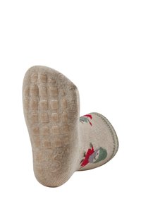 Texturierte beige Socke mit einem gemusterten Design, das einen Schneemann zeigt. Die Sohle verfügt über rutschfeste Quadrate für verbesserten Halt.