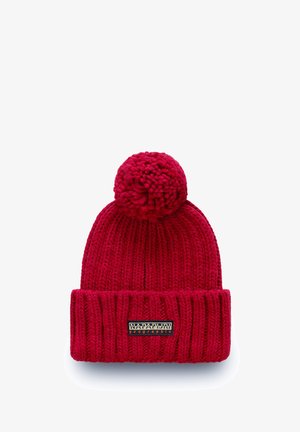 Red knitted beanie with a wide ribbed cuff, a pom-pom on top, and a stitched brand label on the cuff.