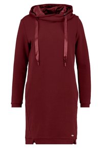 Vestido sudadera burdeos con capucha forrada de satén, cordones ajustables, puños acanalados y aberturas laterales para mayor comodidad al moverse.