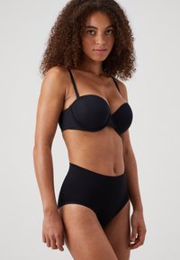 Black bra with molded cups and adjustable straps paired with high-waisted black briefs. Both made from smooth, stretchy fabric.