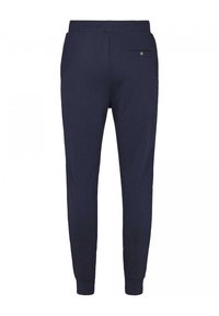 Marina joggerbyxor tillverkade av mjukt bomullsmaterial med en slim fit, elastisk midja, ribbade fållar och en bakficka med knapp.