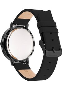 Zwarte siliconen horloge met een ronde kast, helder glazen wijzerplaat en een beige binnenvoering. Heeft een minimalistisch ontwerp en een verstelbare band.
