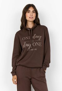 Brown hoodie with a cowl neck, featuring a printed design that reads "ONE day or day ONE YOU DECIDE." Soft fabric, relaxed fit.
