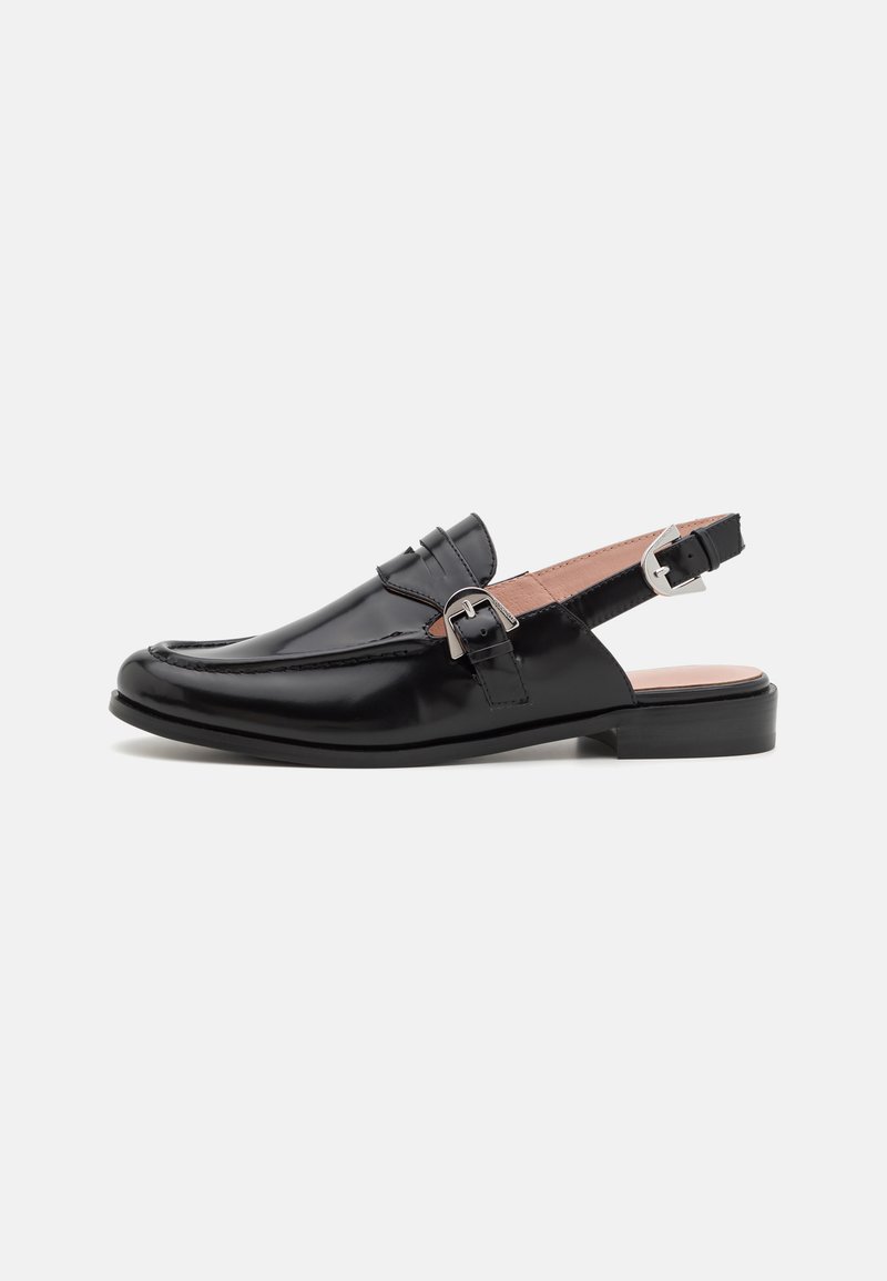 Black patent leather slingback shoe with a rounded toe, decorative strap, and silver buckle accent on the side. Low block heel.