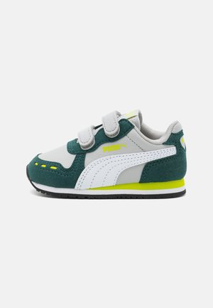 Child's Puma sneaker with white and green suede, two velcro straps, yellow logo, and black sole on a plain background.