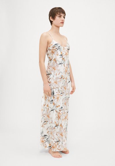 Floral maxi dress with thin straps, featuring orange and green flower patterns on a white background. Lightweight fabric and flowing design.