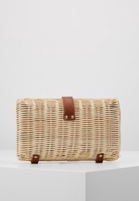 Woven straw bag with a rectangular shape, light beige color, and a brown leather strap featuring brass hardware accents.