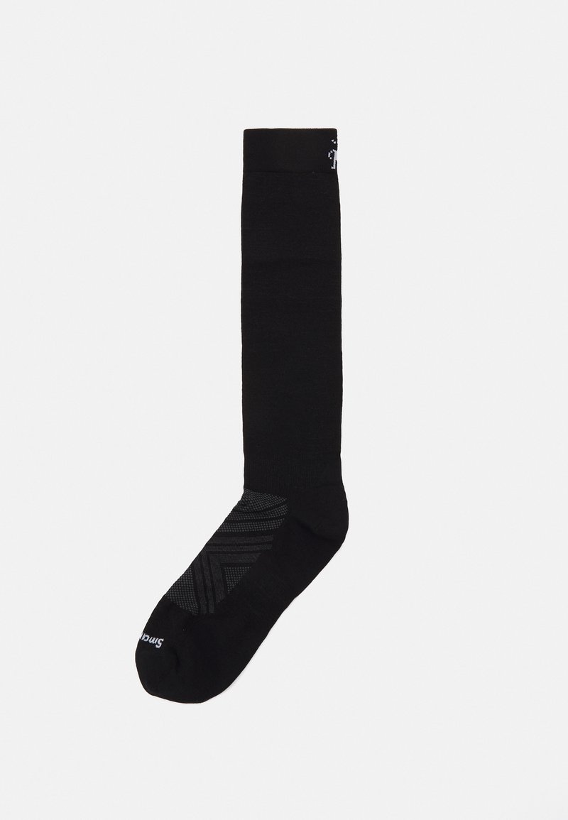 Calcetín negro por encima de la pantorrilla con una suela texturizada negra que presenta un patrón geométrico y un logotipo en la parte superior. Material suave en todo el calcetín.