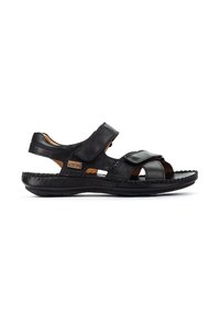 Svart lädersandal med kardborreband, öppen design och texturerad sula. Har vadderad fotbädd och kontrasterande bruna accenter.