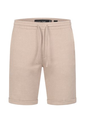 Shorts en mélange de coton beige avec un tissu texturé, taille à cordon de serrage et ourlets roulés. Design simple sans poches ni accents supplémentaires.