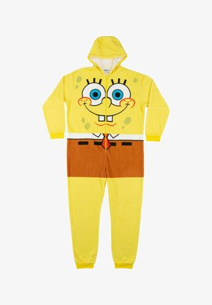 Tuta in pile gialla con cappuccio, caratterizzata da un design con faccia di cartone animato. Include occhi blu, pantaloni marroni e linee nere per i dettagli.