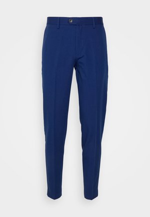 Pantaloni sartoriali blu navy realizzati in un tessuto liscio, con chiusura a bottone e gamba affusolata. Nessun motivo o accentuazione aggiuntiva.