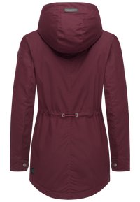 Maroon outdoor jacket with a hood, drawstring waist, snap cuffs, and smooth texture. Features a label on the neckline and logo detail.