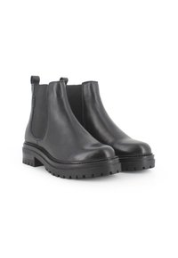 Botas Chelsea de cuero negro con punta redondeada, paneles laterales elásticos y una suela de goma gruesa y texturizada. Diseño sencillo con un acabado elegante.