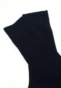 Calzini blu navy realizzati in un morbido materiale a maglia a coste con una texture liscia e un design semplice. Presentano un bordo superiore per il comfort.