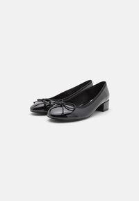 Black patent leather ballet flats with a round toe, a small block heel, and a decorative bow on the front. Smooth texture throughout.