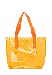 Prozoren oranžni torba z ojačanimi ročaji, pravokotne oblike, s tiskom "BAG" v belem. Narejena iz plastičnega materiala.