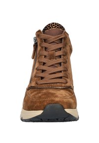 Brown suede sneaker with textured tongue, flat brown laces, side zipper, and a black rubber sole. Features a leopard print accent on the collar.