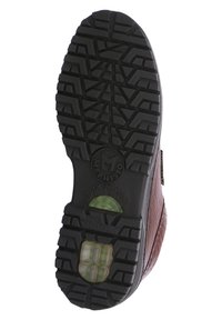 Semelle en cuir marron avec caoutchouc noir texturé, dotée d'un système d'absorption des chocs et d'un motif de semelle distinctif pour une meilleure adhérence.