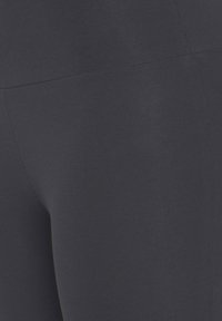 Navy stretch leggings in soft fabric, featuring a seamless design with a smooth texture and no visible hardware or patterns.