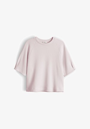 Light pink short-sleeve crew neck textured shirt with raglan sleeves and a straight hem, displayed flat on a white background.
