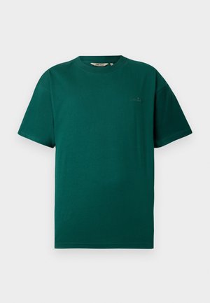 Krátký rukáv tričko v tmavě zelené barvě z bavlny, s kulatým výstřihem a jemným logem na hrudi. Hladká textura a uvolněný střih.