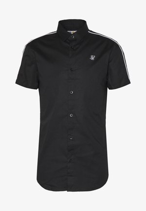 Chemise noire à manches courtes en coton avec fermeture à boutons, présentant des rayures blanches sur les épaules et un logo brodé sur la poitrine.
