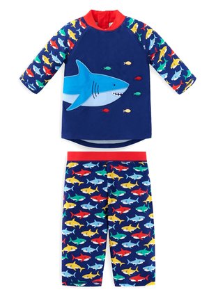 Blue shark-themed swim shirt with short sleeves and a red collar, paired with patterned swim shorts featuring colorful sharks on a dark background.