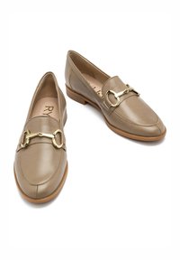 Jasnobeżowe skórzane loafersy z okrągłym noskiem, niskim obcasem i akcentem z hardware'u w kolorze złotym w kształcie wędzidła na przodzie.