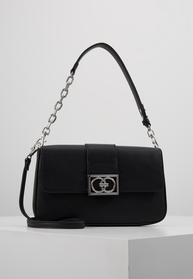 Black leather handbag with silver chain and clasp featuring interlocking circle design, displayed on white surface with gray background.