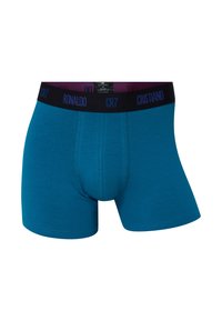 Herre boxershorts i turkis bomuld med en sort elastisk taljebånd, hvor "CR7" og "RONALDO" er tydeligt vist, glat tekstur.