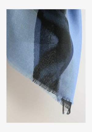 Light blue scarf with a textured weave, featuring a gradient pattern merging deep blue and black. Fringed edges add detail.