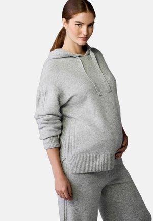 Grau gestrickter Hoodie mit Kängurutasche, geripptem Saum und Kapuze mit Kordelzug. Kombiniert mit passenden Hosen, die eine lockere Passform zeigen.