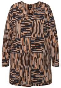 Dlouhý rukáv top vyrobený z elastického materiálu s geometrickým vzorem v béžové a námořnické modři s různou šířkou čar a tvary.