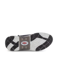 Semelle de chaussure de sport en noir et blanc avec des motifs de bande de roulement texturés, présentant des rainures pour une meilleure adhérence, et un logo au centre.