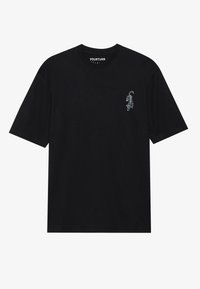 T-shirt en coton noir avec une coupe décontractée. Présente un petit graphisme blanc d'un tigre en train de sauter sur la zone gauche de la poitrine. Manches courtes.