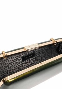Green and black clutch bag with a glossy finish, gold hardware, and a rhinestone clasp; lined interior features a subtle patterned texture.