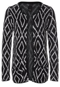 Cárdigan de patrón blanco y negro con diseño de diamante, de frente abierto, con mangas largas y dos bolsillos delanteros. Tejido de punto texturizado.