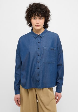 Denim button-up shirt in dark blue with a classic collar, single chest pocket, and front button closure. Relaxed fit with long sleeves.