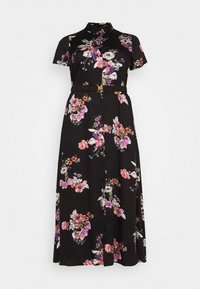 Musta kukkakuvioinen mekko, jossa on lyhyet hihat, kauluksellinen pääntie, napitus edessä ja vyötäröllä vyö. Kukkaprintti vaaleanpunaisena, valkoisena ja violetina.