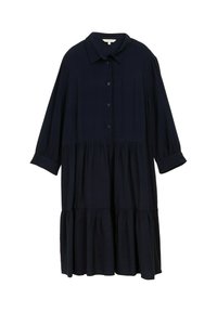 Mörkblå, löst sittande skjortklänning med krage, knappframsida och långa ärmar. Har en flerlagrad, volangkant. Mjuk tygkänsla.