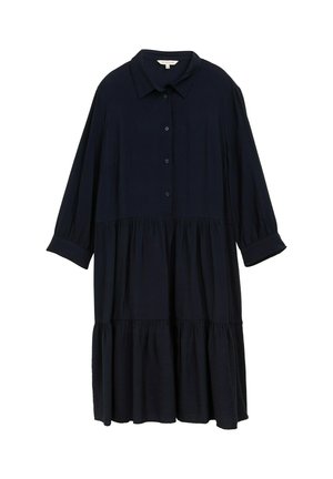 Dunkelblaues, locker sitzendes Hemdkleid mit Kragen, Knopfleiste und langen Ärmeln. Verfügt über einen gestuften, rüschierten Saum. Weicher Stofftextur.