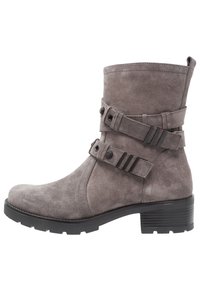 Gray suede ankle boot with two contrasting straps and metal accents, a rounded toe, and a chunky heel. Textured surface with stitching details.