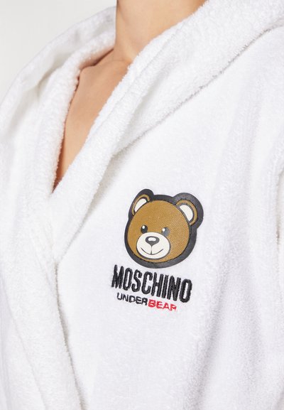 White terry cloth bathrobe featuring a bear logo; embroidered "Moschino UnderBear" in black and red; shawl collar design.