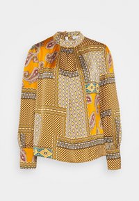Blouse à manches longues avec une base jaune ornée d'un mélange de motifs cachemire, géométriques et floraux. Col montant et fermeture par bouton au niveau du cou.