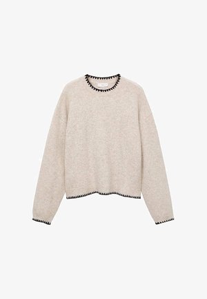 Jersey beige de punto con mangas largas, con ribete en zigzag negro en el escote, los puños y el dobladillo.
