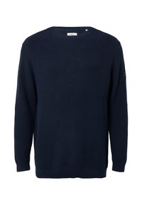 Navyblauwe gebreide trui met een ronde hals, lange mouwen en geribde manchetten. Heeft een gestructureerde stof en een subtiel logo op de mouw.