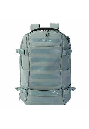 Sac à dos Hedgren gris compact avec sangles latérales réglables, compartiments avant zippés et bretelles rembourrées.